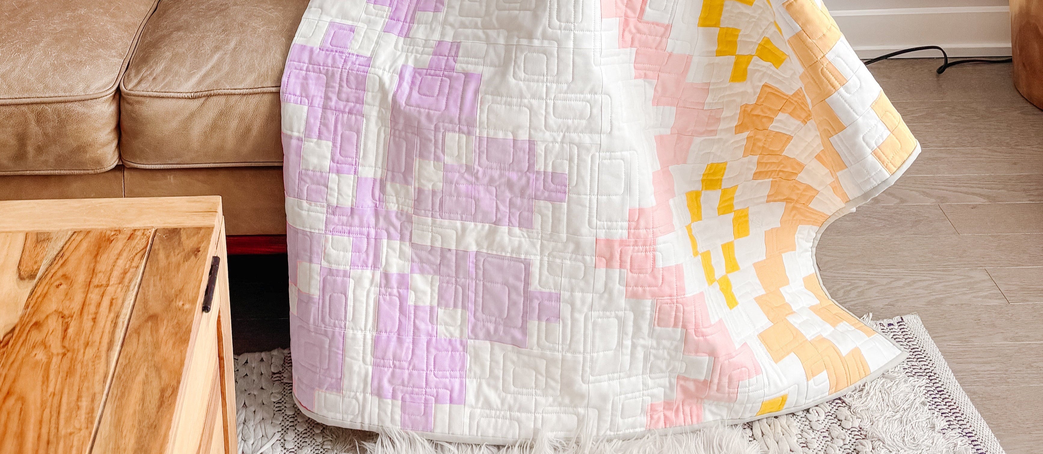 Colorful quilt draped over a sofa in a living room setting